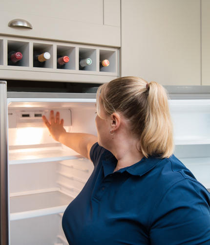 Dg Engineer Adjusting Temperature On Freezer